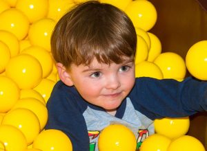 Toddler in ball pond at Dino Soft Play