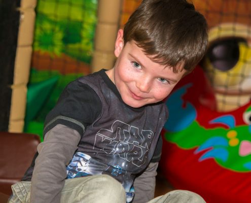 Child playing at Dino Soft Play