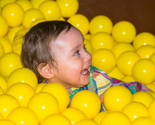 Baby in Dino Soft Play Ball Pond